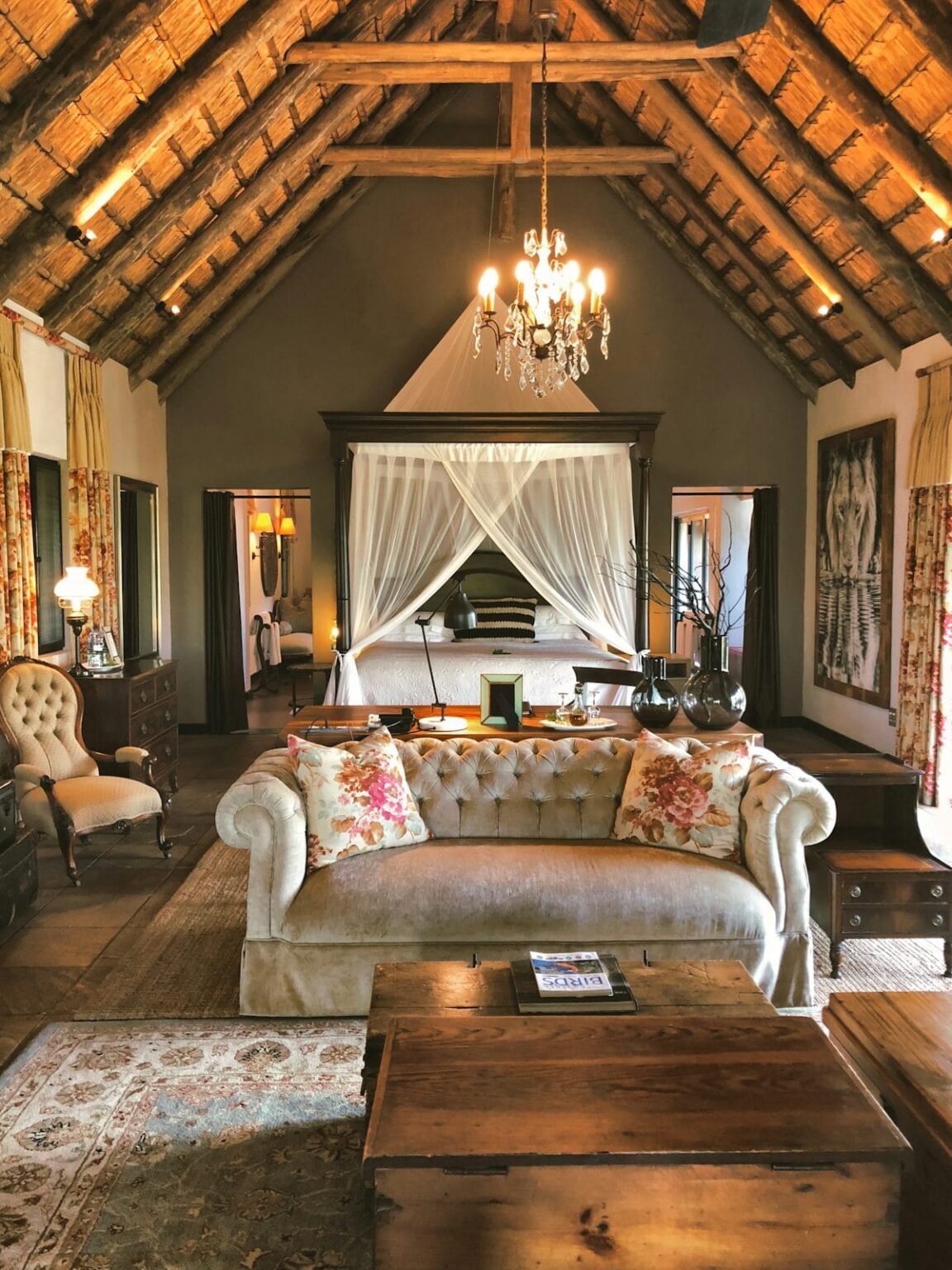 Luxury Safari lodge interoir with thatched roof and legant canopy bed
